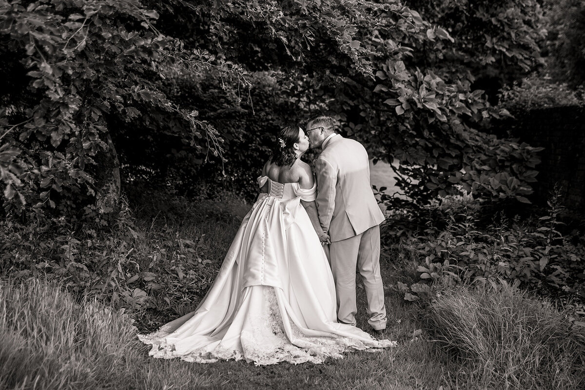 Bride wearing a bustled gown with soft off the shoulder cap sleeves