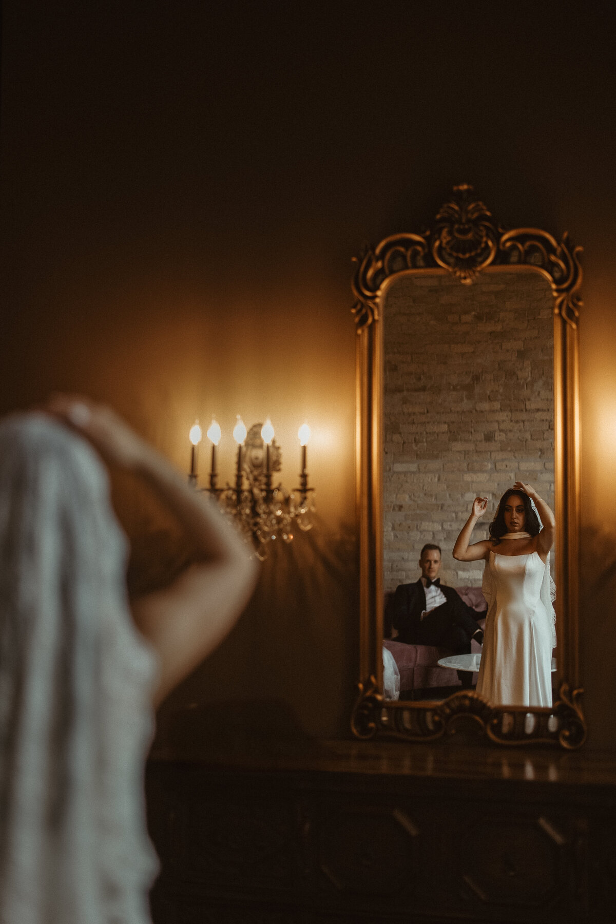 Bride and groom getting ready together in the mirror captured by Clewell Photography