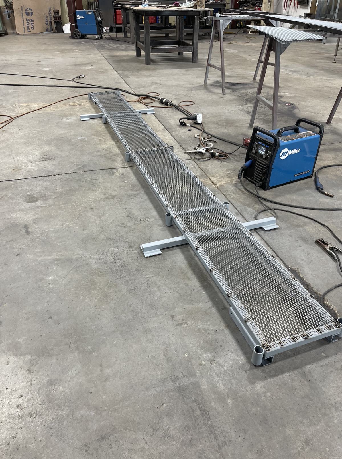 Welding equipment used to fabricate a custom steel grate designed for heavy-duty industrial applications.”