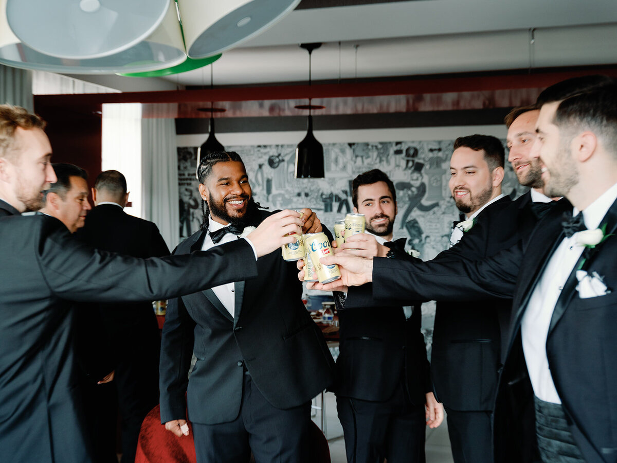 Groom party cheer and take shots before the wedding at Hotel Washington in DC