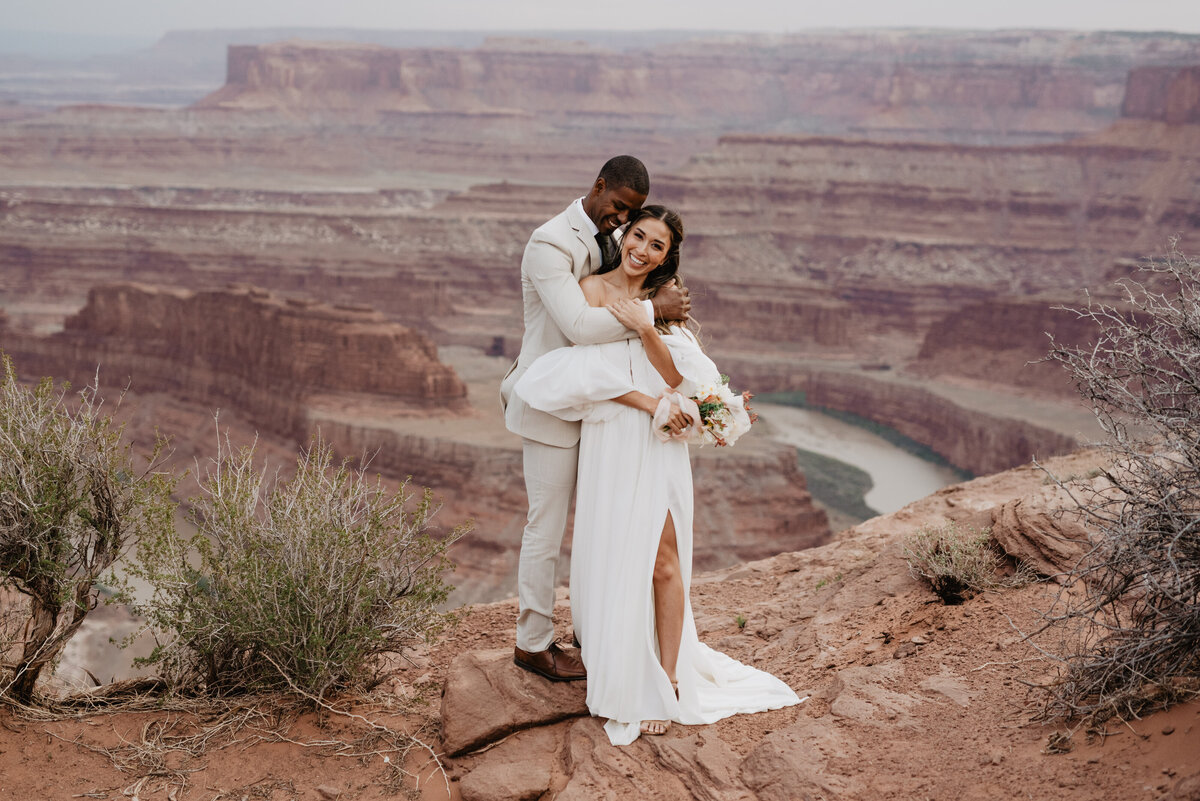 Utah Elopement Photographer captures couple hugging on red rock