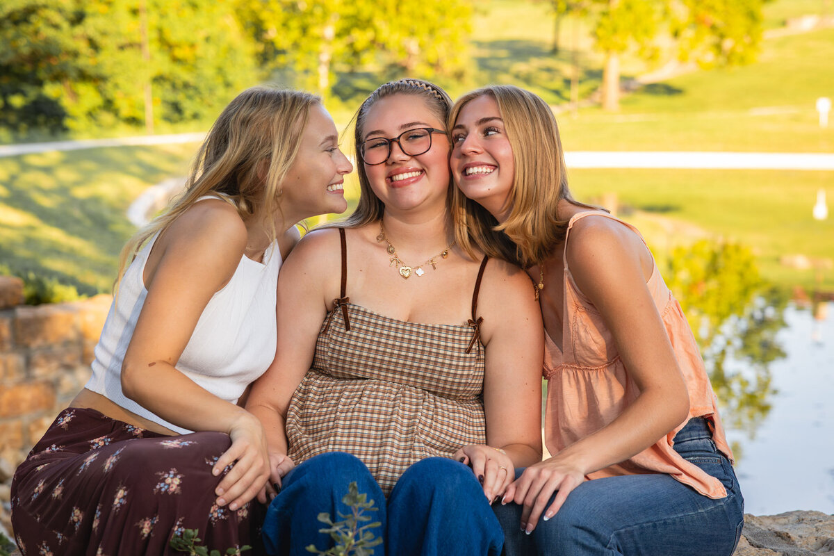 MBP Senior Team sitting next to each other looking at each other smiling in Lawrence, KS