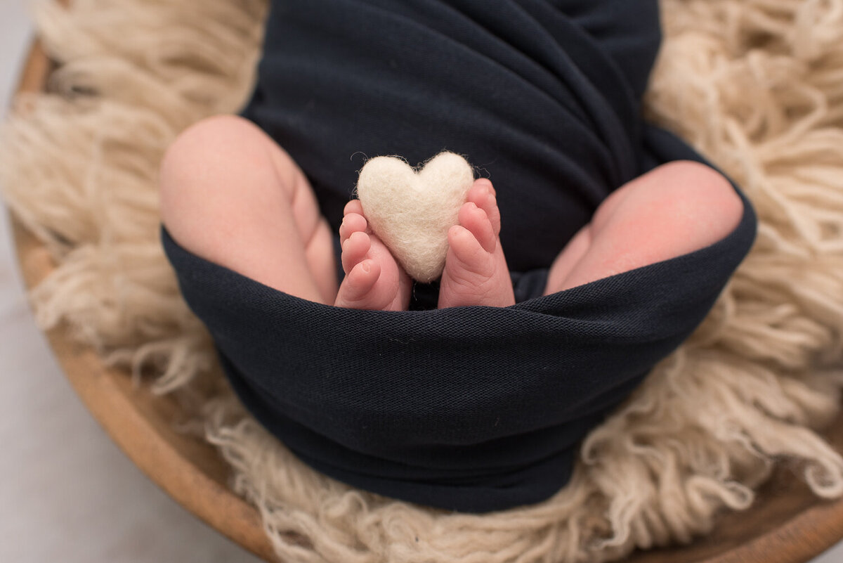 Close up of newborn boy toes holding white heart |Sharon Leger Photography | Canton, CT Newborn & Family Photographer
