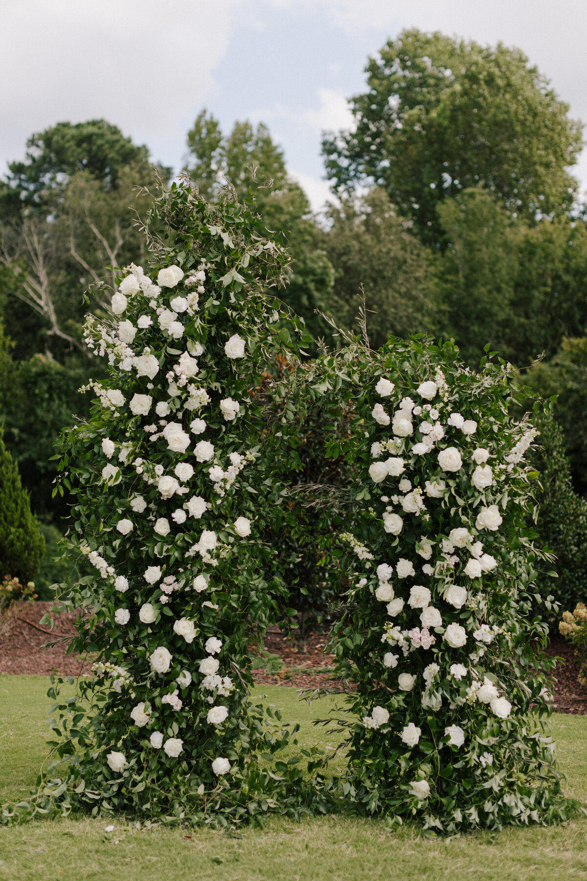 white floral pillars for ceremony