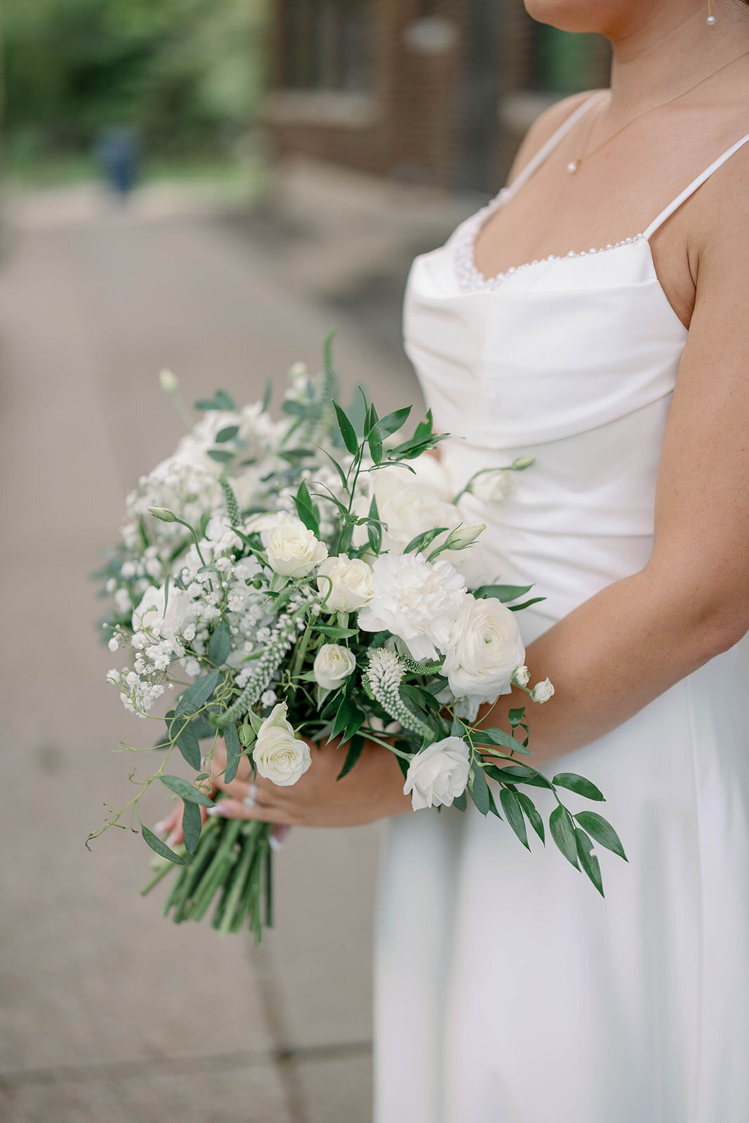 Detail photo of the bride’s white and green bouquet featuring soft garden florals from a modern wedding at Leona Road in Grand Rapids Michigan.