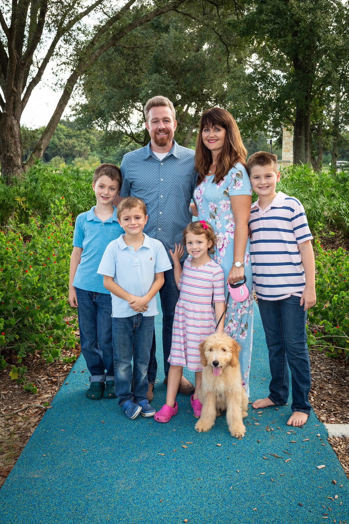 family of six and their dog in a park