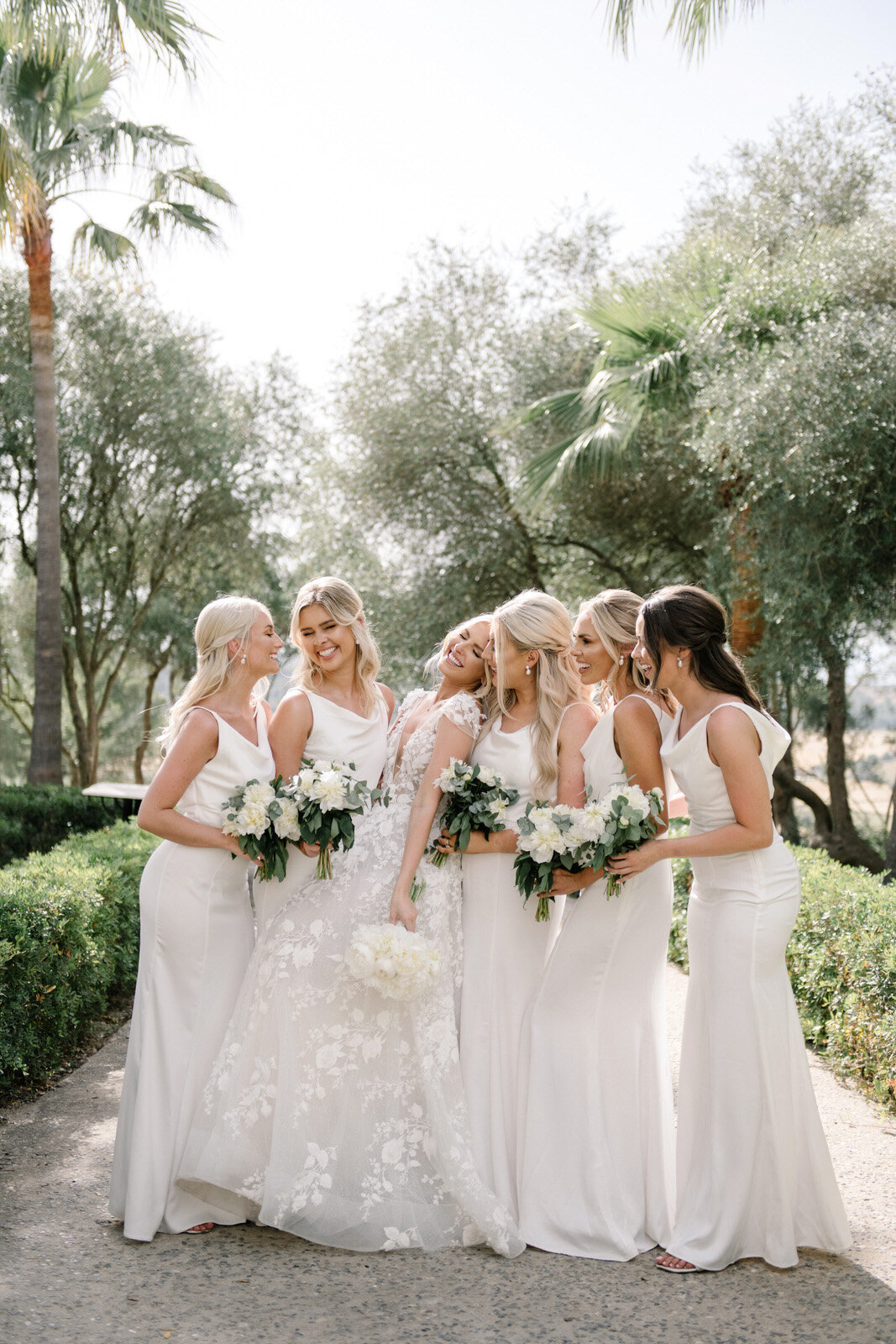 bridesmaids in white dresses at finca serena mallorca by photographer maria hibbs