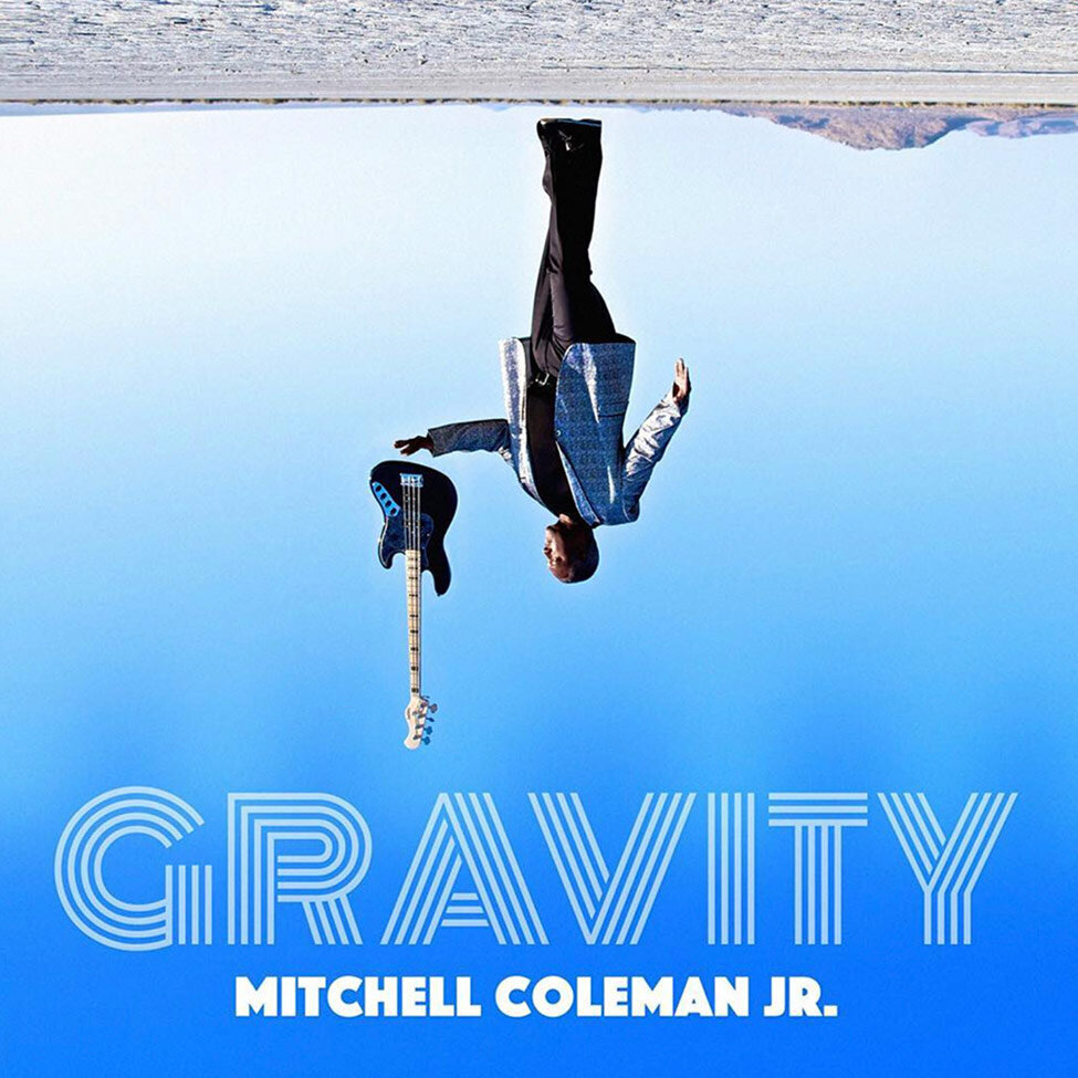 Album Cover Title Gravity Artist Mitchell Coleman Jr standing in desert image upside down guitar floating above his outstretched hand
