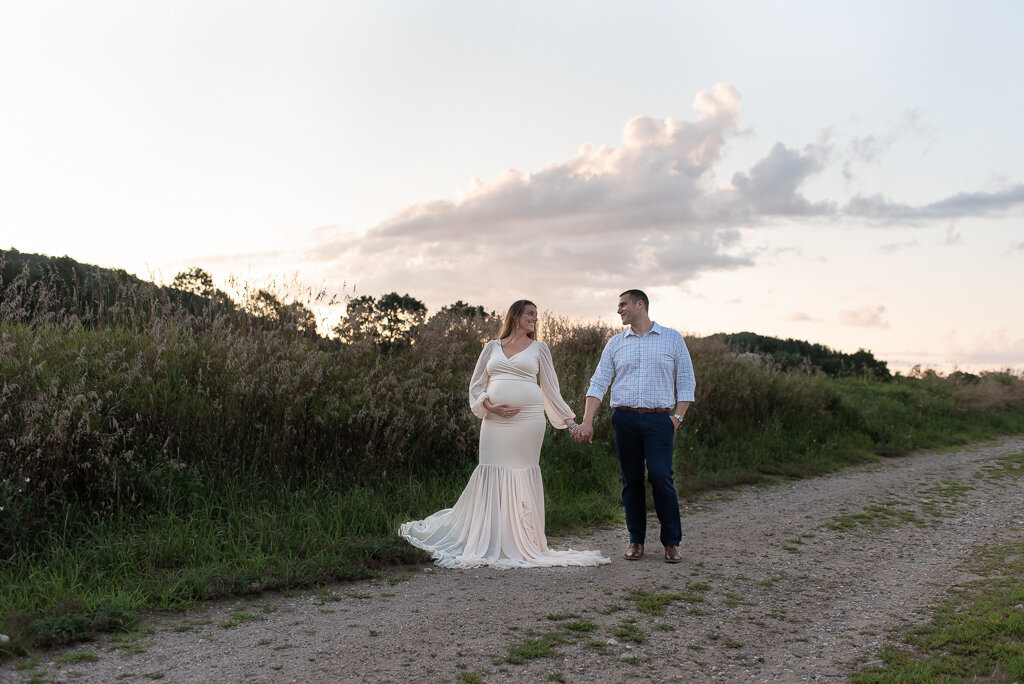 Couple holding hands at sunset maternity session in CT field | Sharon Leger Photography | CT Newborn & Family Photographer | Canton, Connecticut