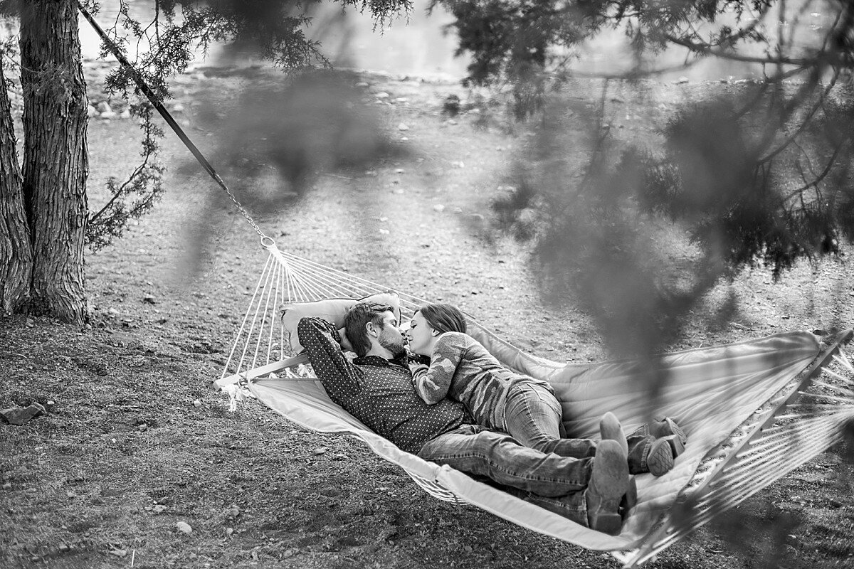 Couple laying in hammock and kissing