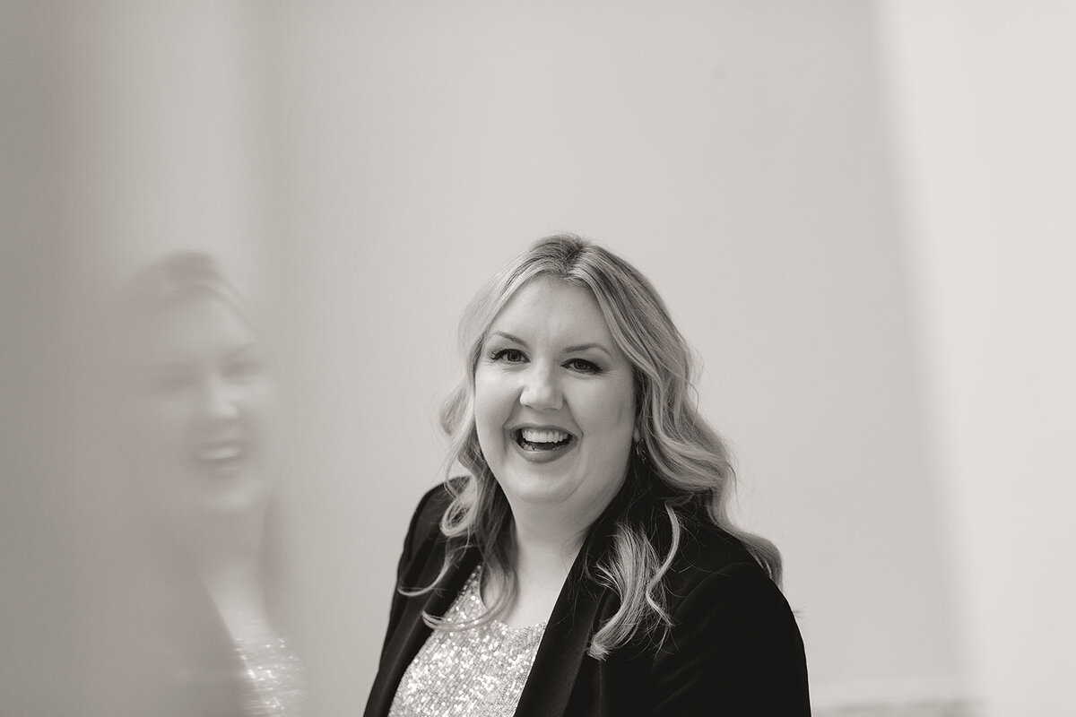 Melissa Lawrence smiles in sparkly blouse and black blazer