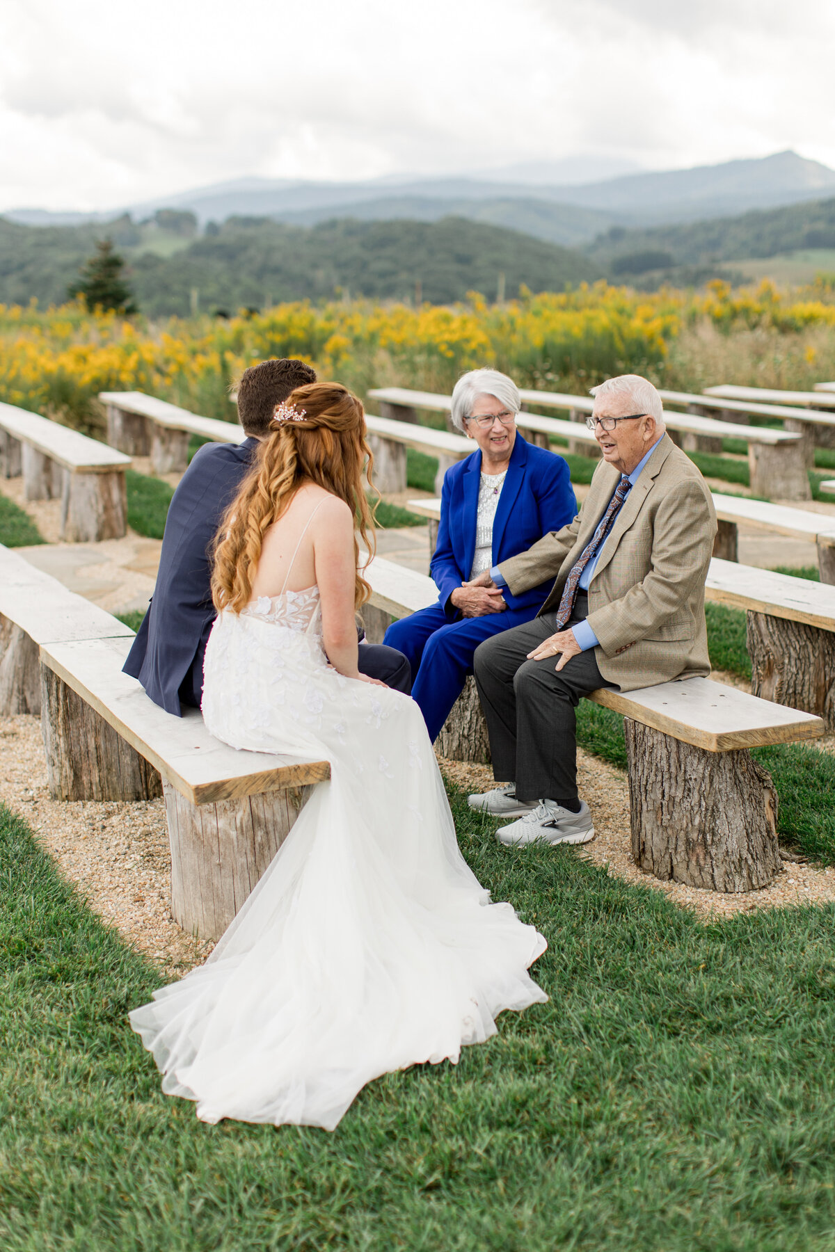 A bride and groom talk with guests during their wedding day in the mountains of Banner elk, NC