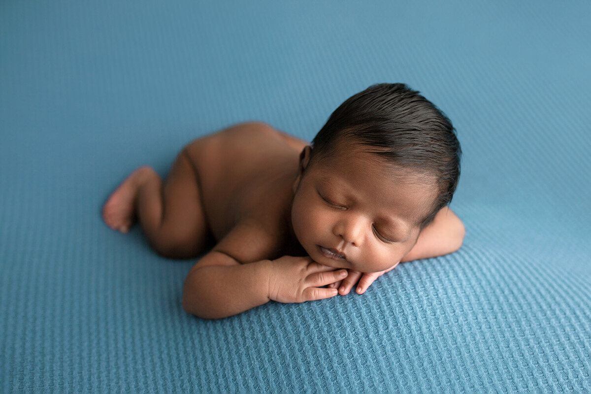 baby boy sleeping on blue blanket