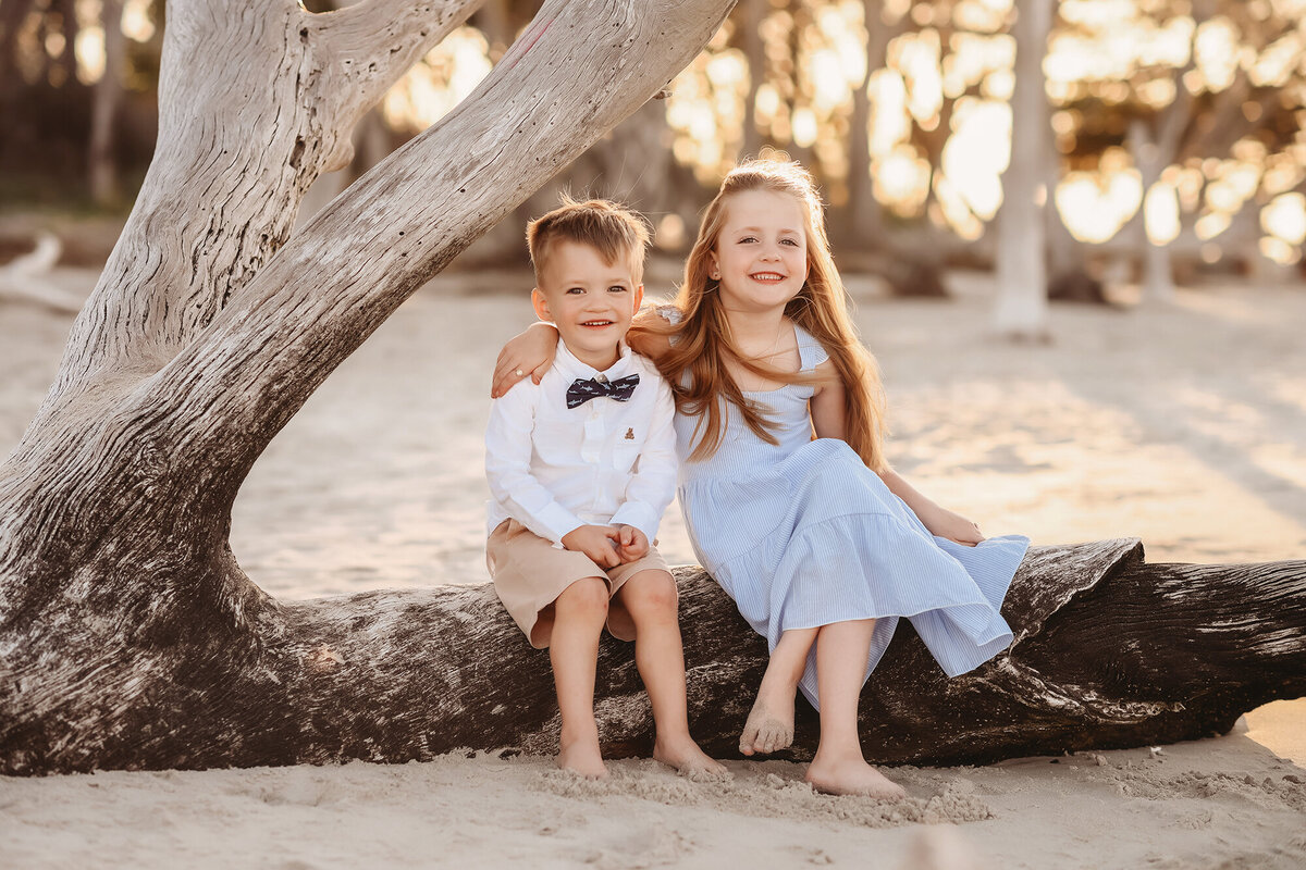 Siblings embrace each other during their Family Photos on Folly Beach. 