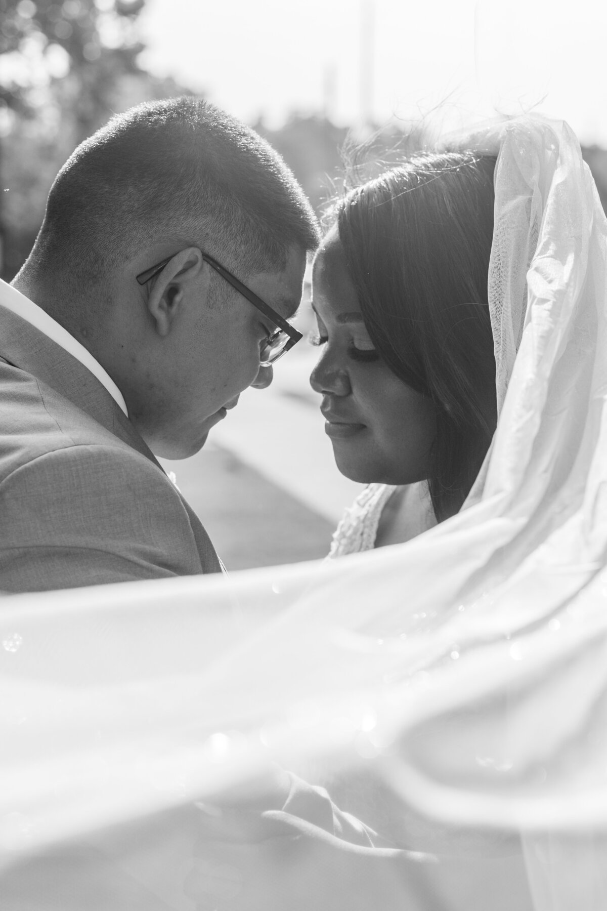 bride and groom closing eyes with veil at Columbus Trade and Convention Center by Columbus Georgia wedding photographer Amanda Richardson Photography