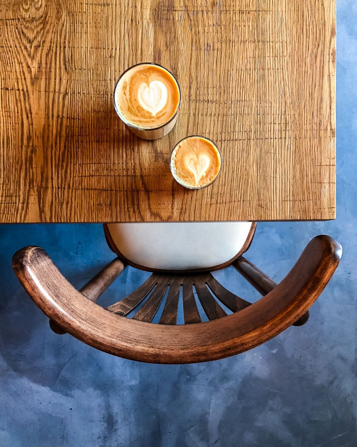 02.-Coffee-Latte-Art-on-wood-table-chair-and-floor-Izu-Brasserie