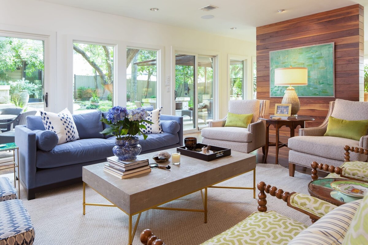 the keeping room interiors grant living room with blue sofa and accent chairs with large sliding doors