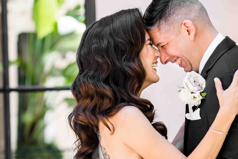 bride-and-groom-laughing-courtyard-the-guild-hotel-san-diego-wedding