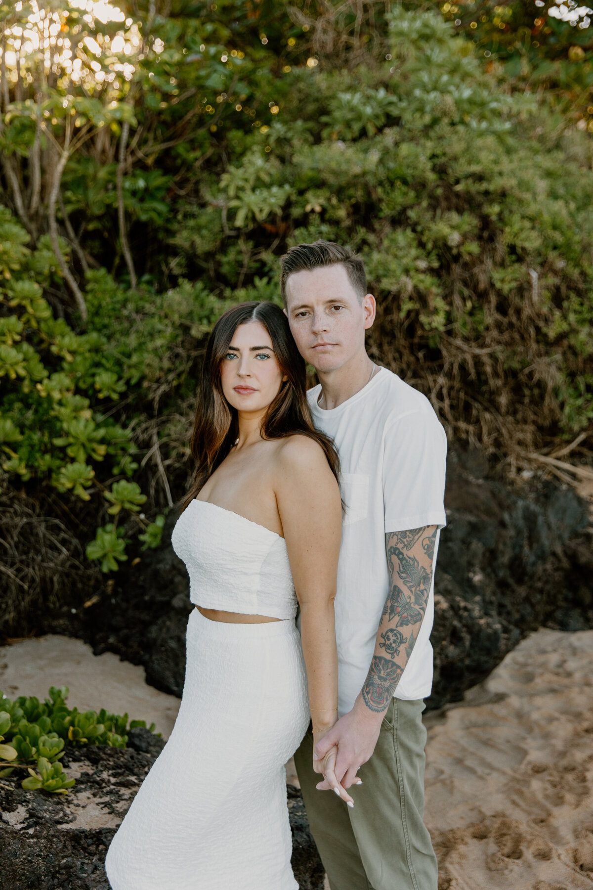Hawaii Engagement Photographer captures couple wearing white during beach engagement photos