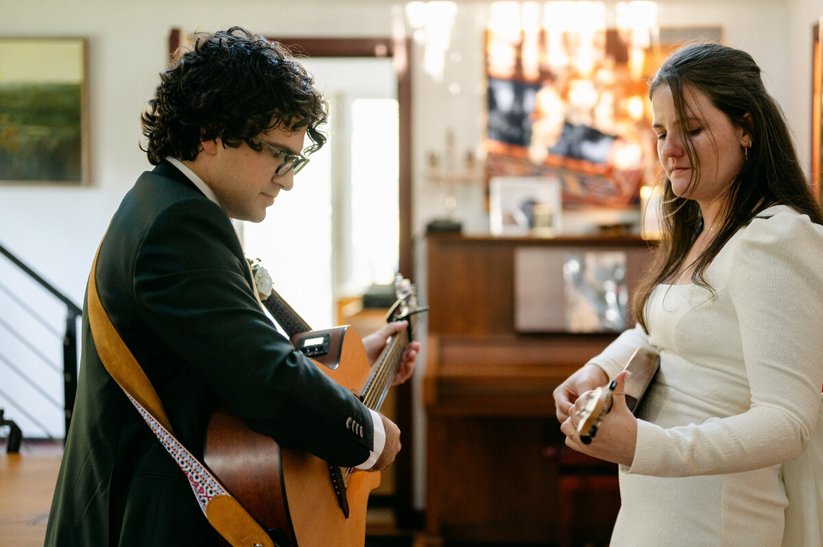 Bride and groom rehearsing with guitars before their wedding