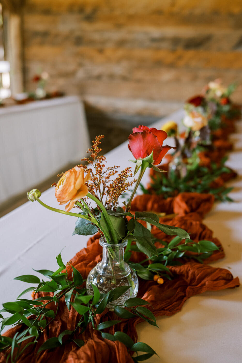 orange-ranunculus-in-bud-vase