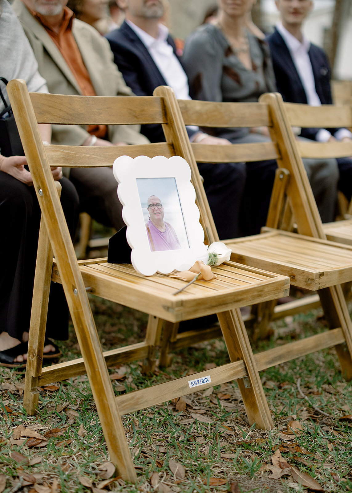 Memoriam frame sitting on a seat at a wedding ceremony