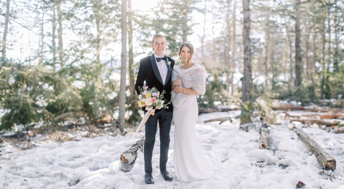 couple posing for a portrait during their winter wedding at the Fairmont Banff Springs in Banff during their winter wedding photographed by Alberta wedding photographer David and Breanne Heidrich
