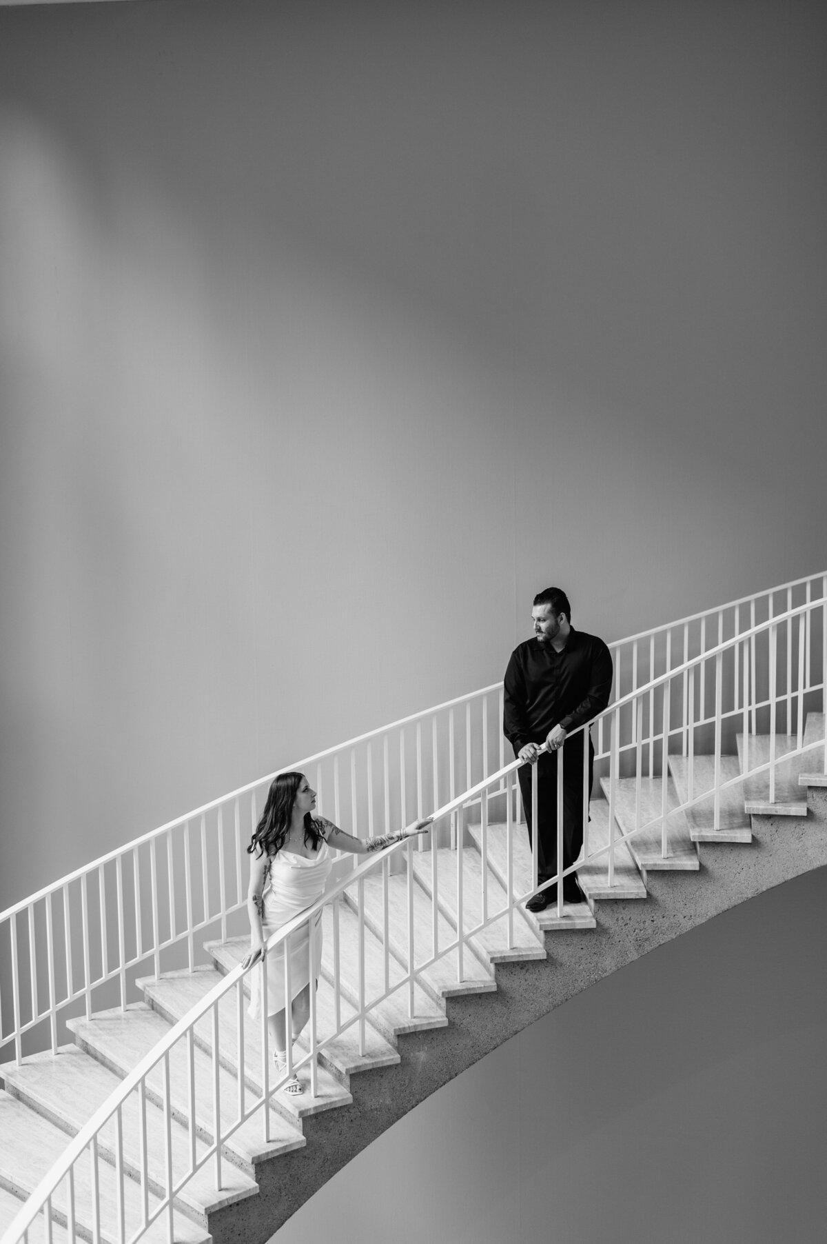 Black and white solo senior portrait on staircase