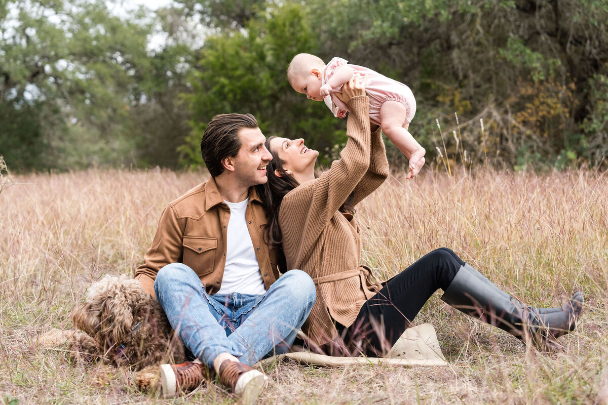 Family plays during a family photoshoot at Circle C Park in Austin, Texas.
