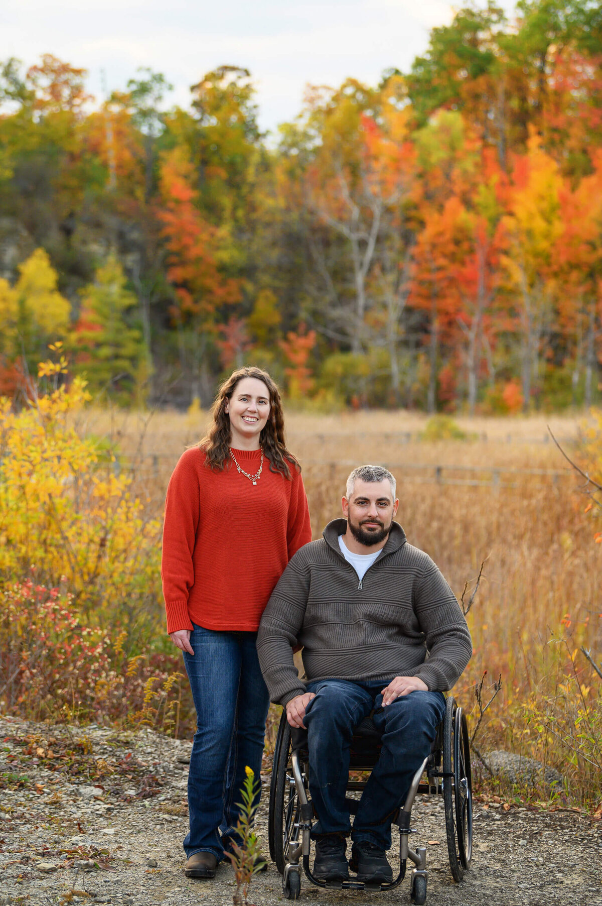 husband in a wheelchair and wife for their extended fall family photos