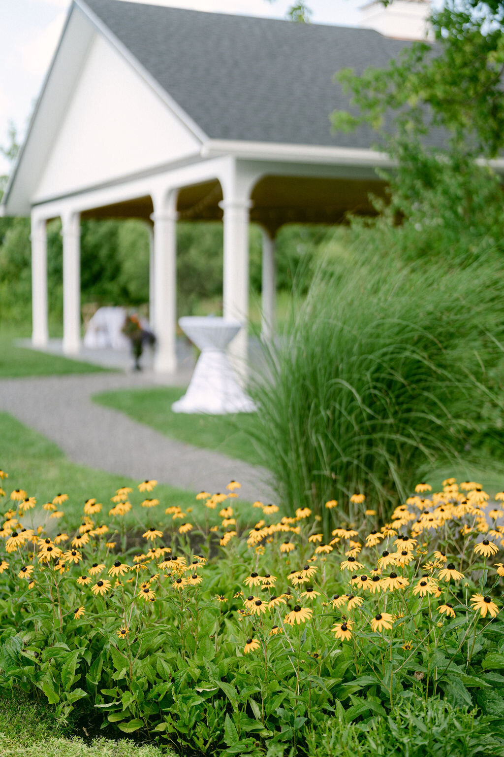 garden with blackeyed susans and grasses in front of event pavilion ready for cocktail hour