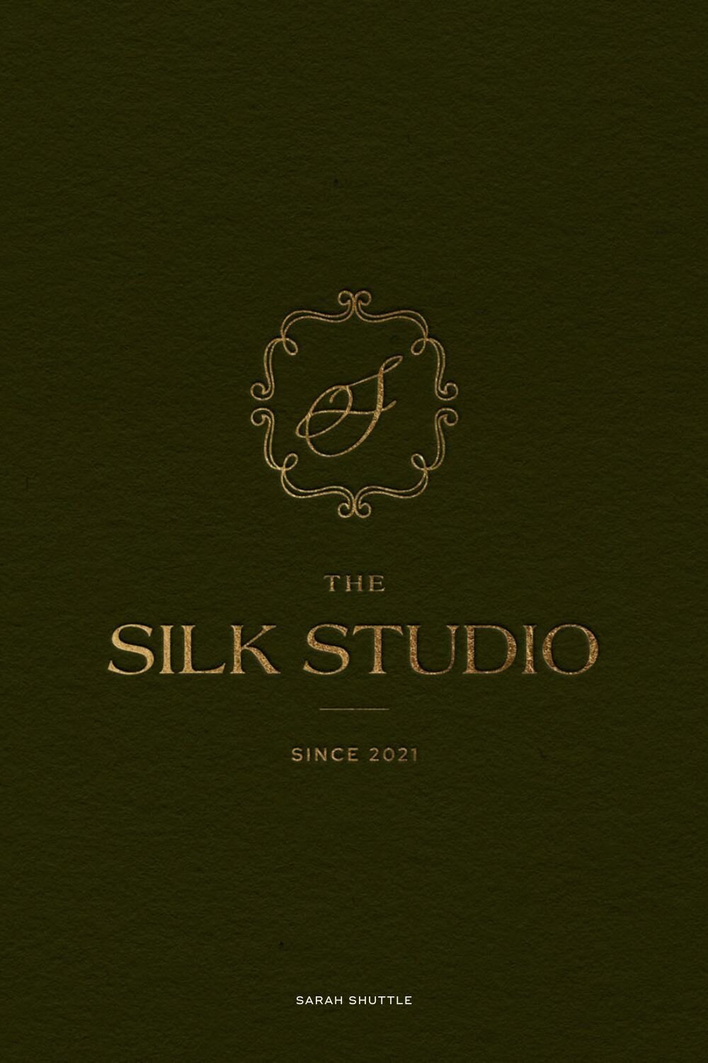 Ornate gold logo design for The Silk Studio set against a deep green textured background