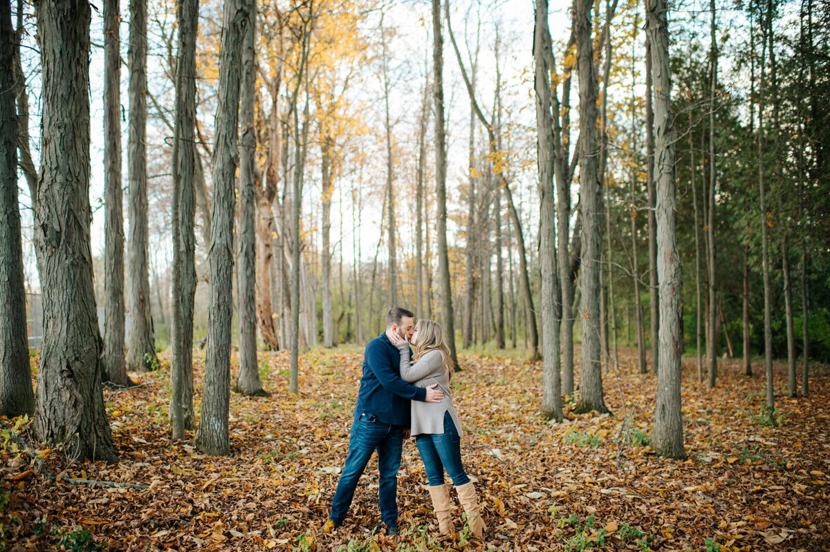 couple kissing in woods in fall lake champlain vermont