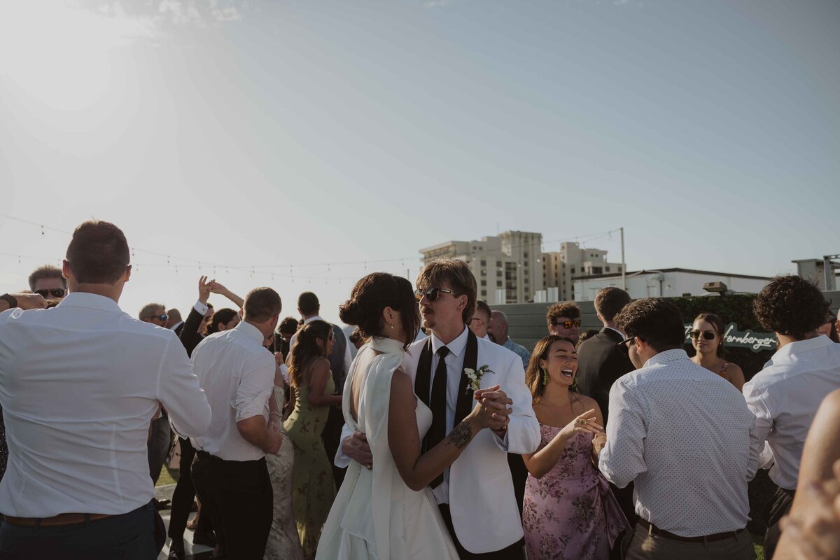A bride and groom holding hands at their Tampa wedding at The Orlo House