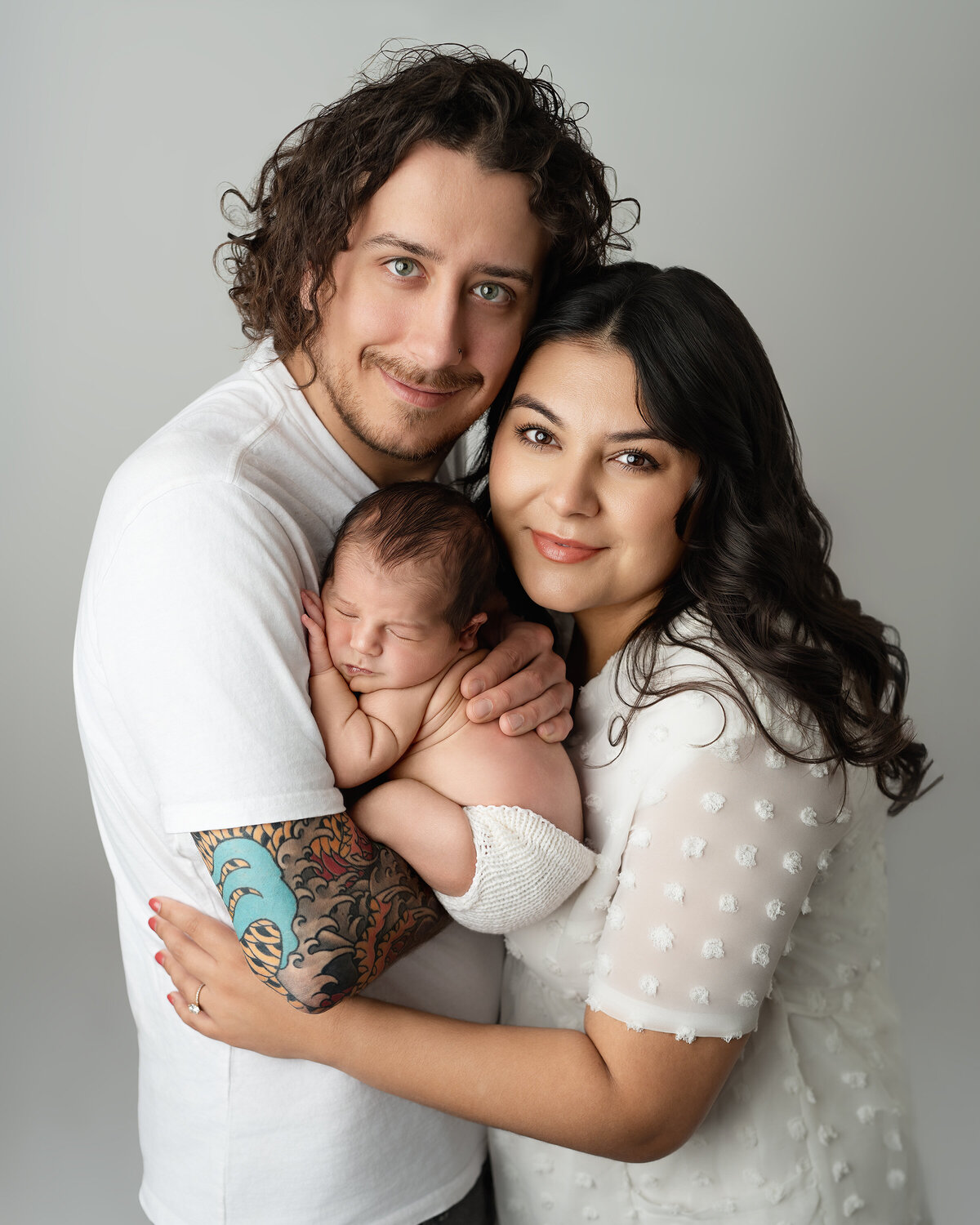 Close-up studio family portrait with parents holding newborn | Paris Ontario photographer