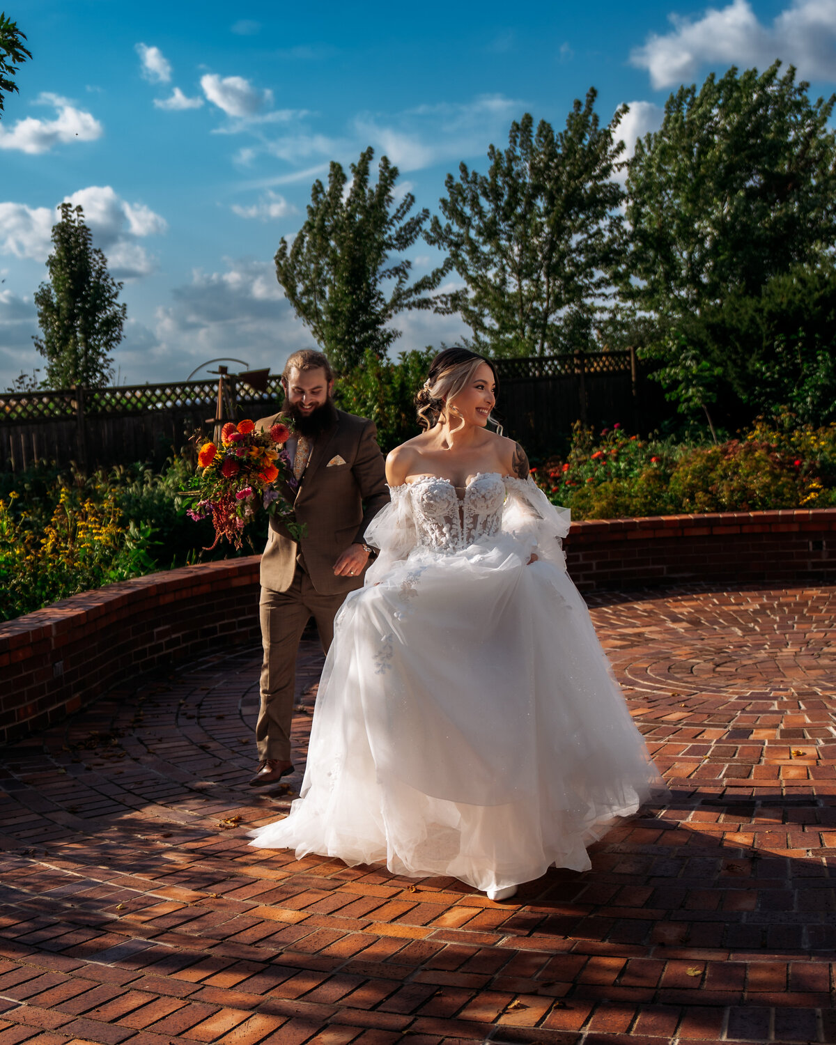 candid wedding photography of couple running and smiling on their wedding day at 1886 Farmhouse wedding venue Boone Iowa