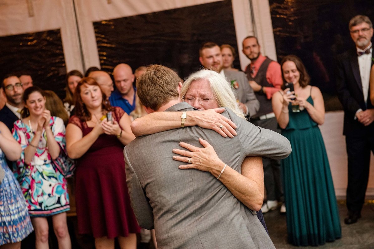 Groom hugging mother at Head of the Bay Club