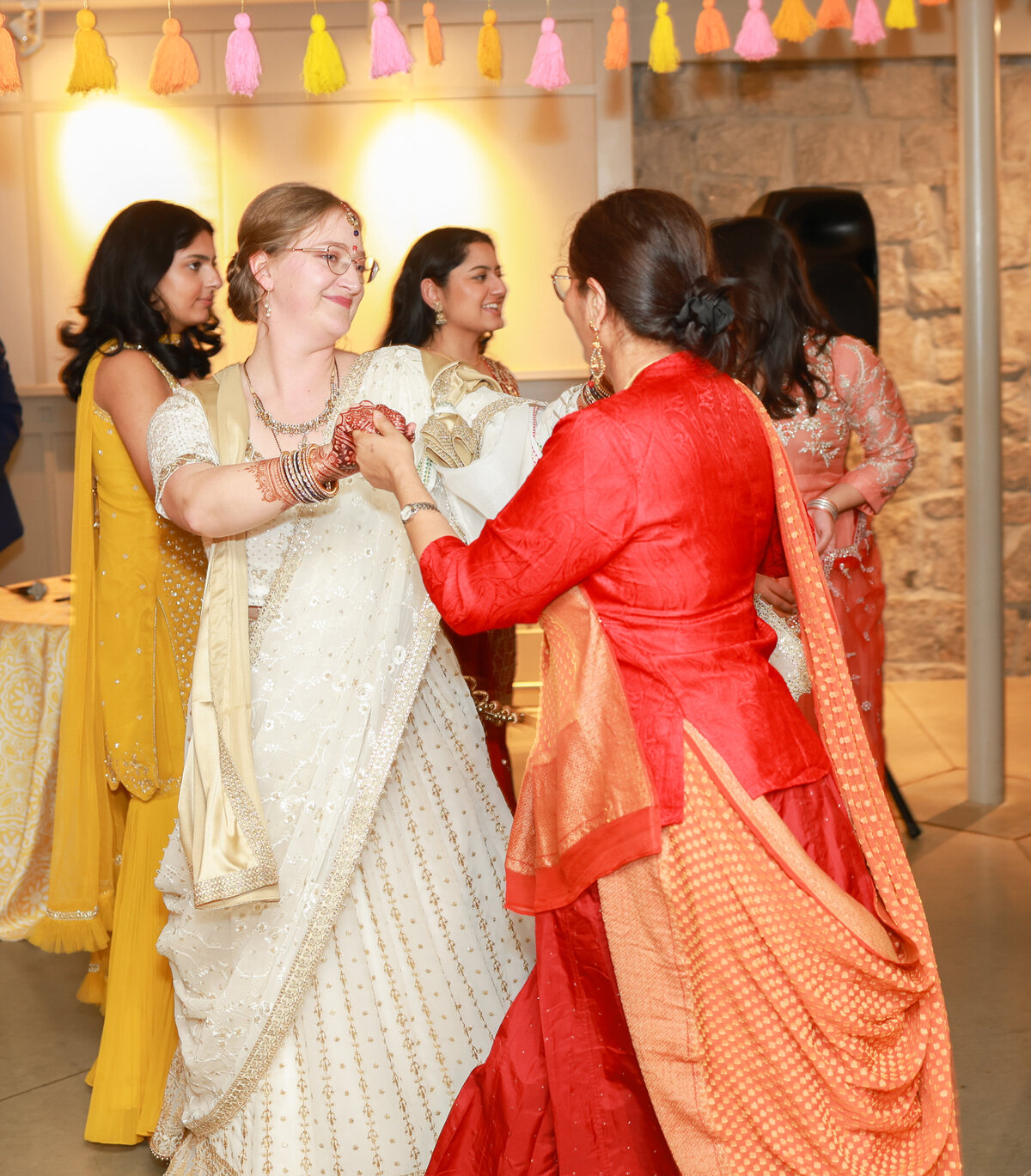 bride and mother in law dancing to Indian music at Piedmont Park Conservatory in Atlanta Georgia by Atlanta Georgia wedding photographer Amanda Richardson Photography