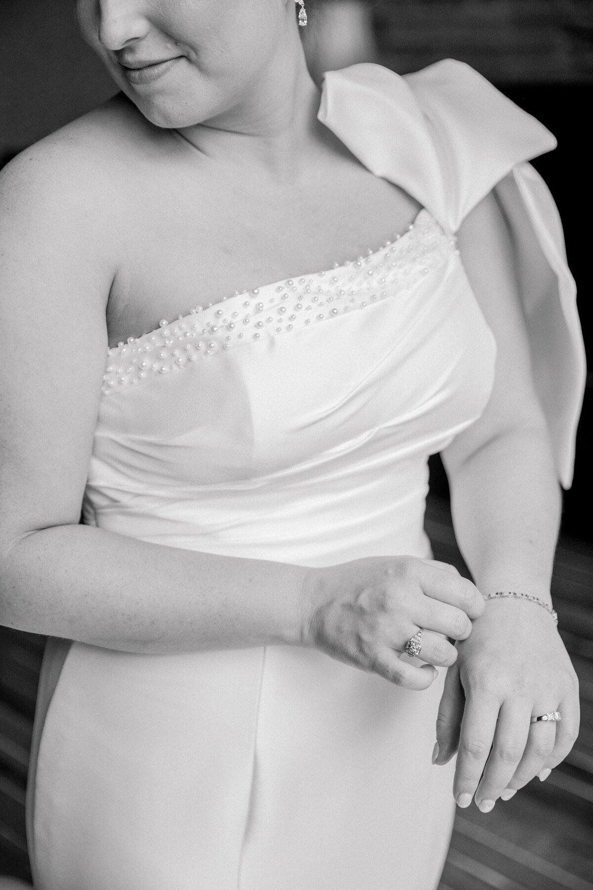 Black and white closeup picture of a bride adjusting her bracelet while getting ready for her Bristol Train Station Wedding.