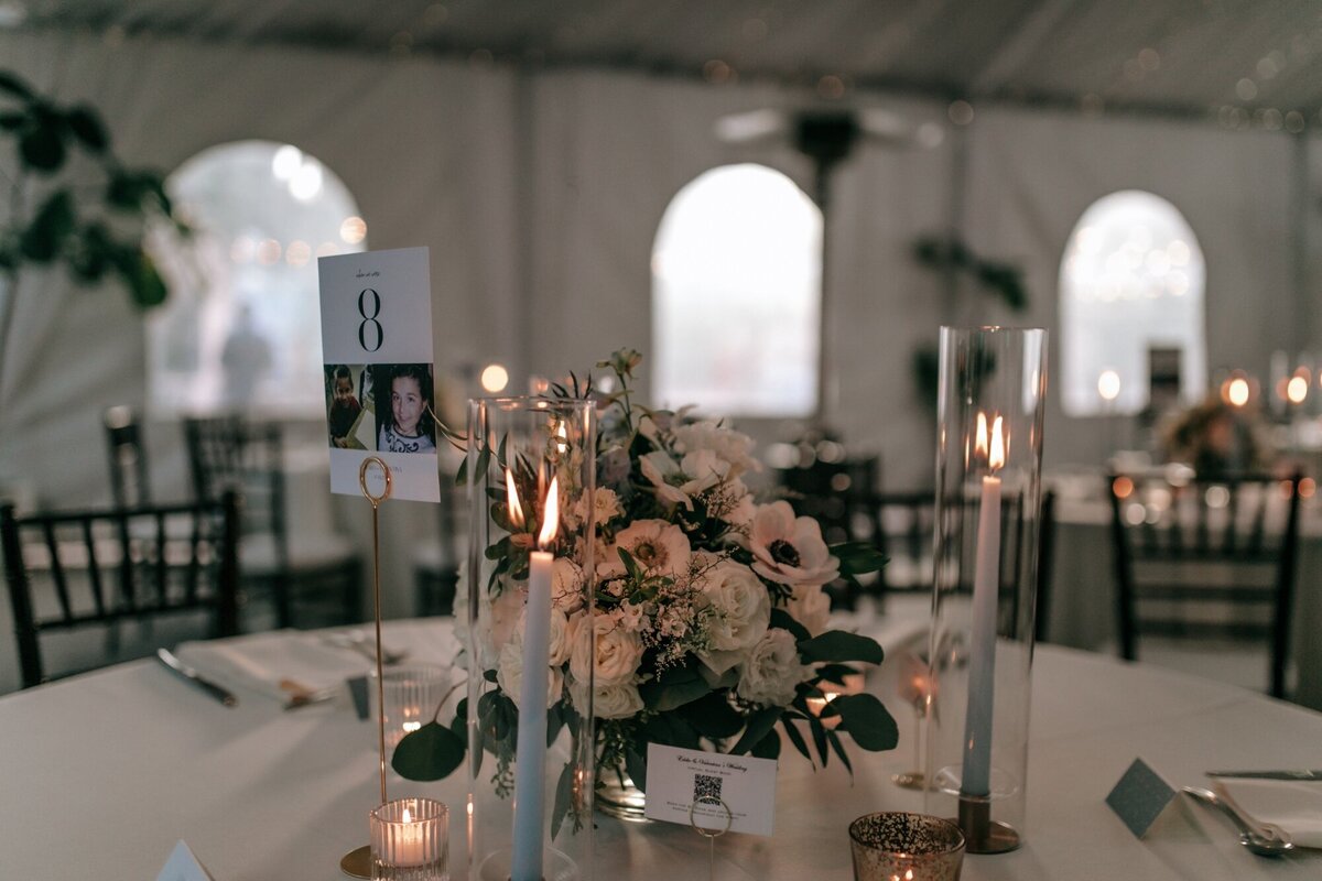 Photo of the wedding table decorations and table number before anyone has been seated.