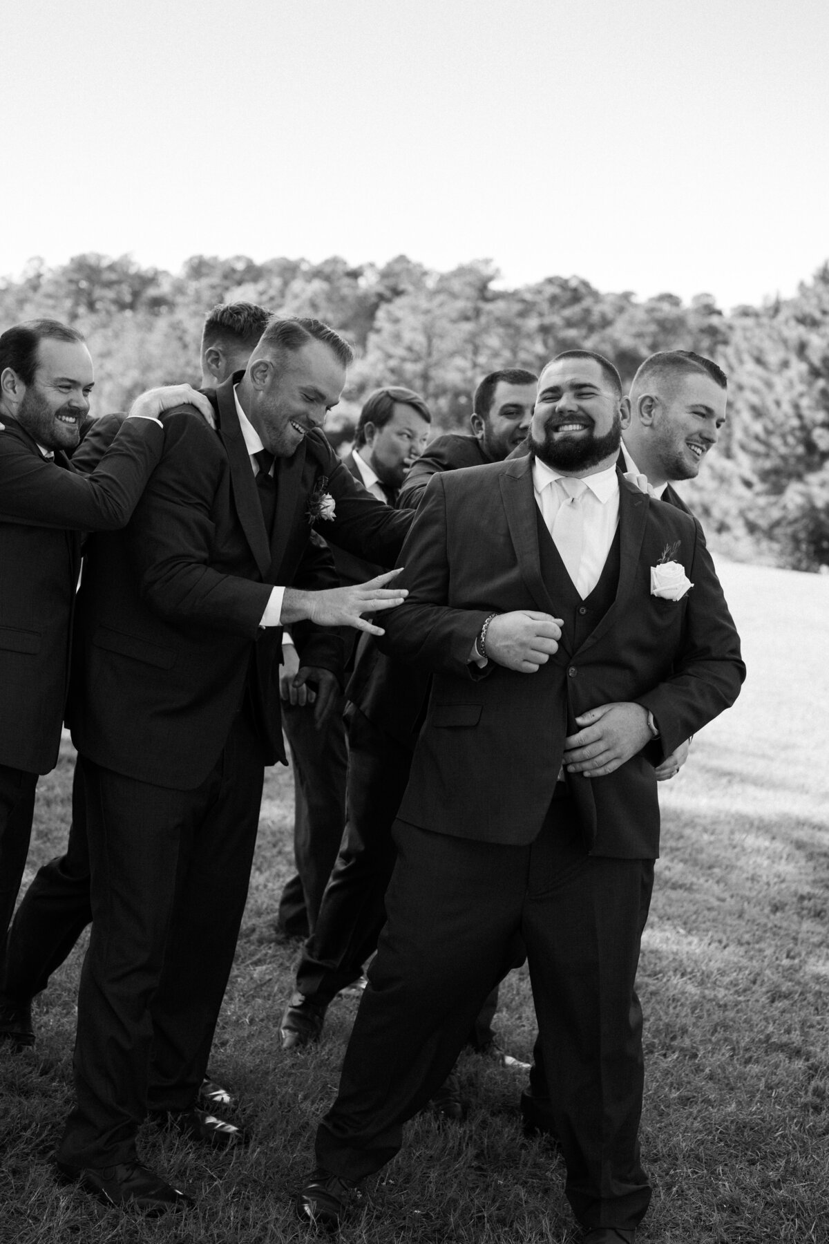 Wedding party congratulating groom