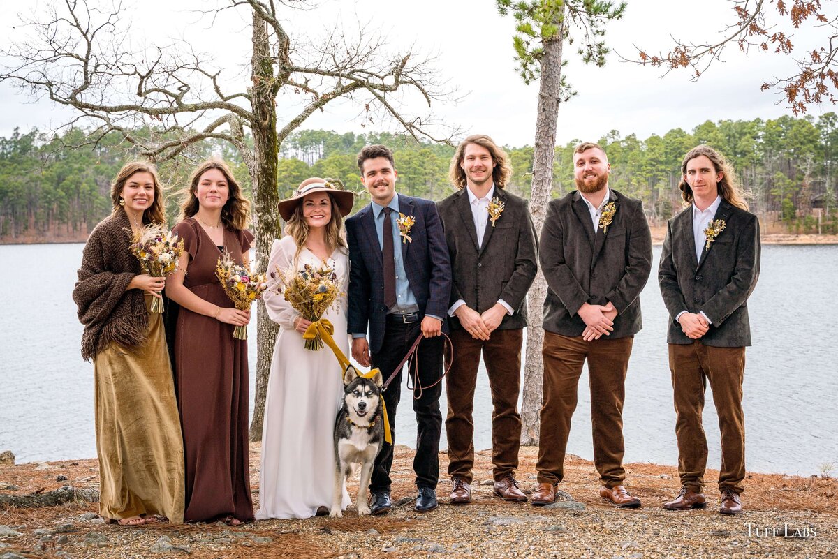 Wedding party is shown with their dried flower bouquets and dried floral boutonnieres at an outdoor winter wedding.