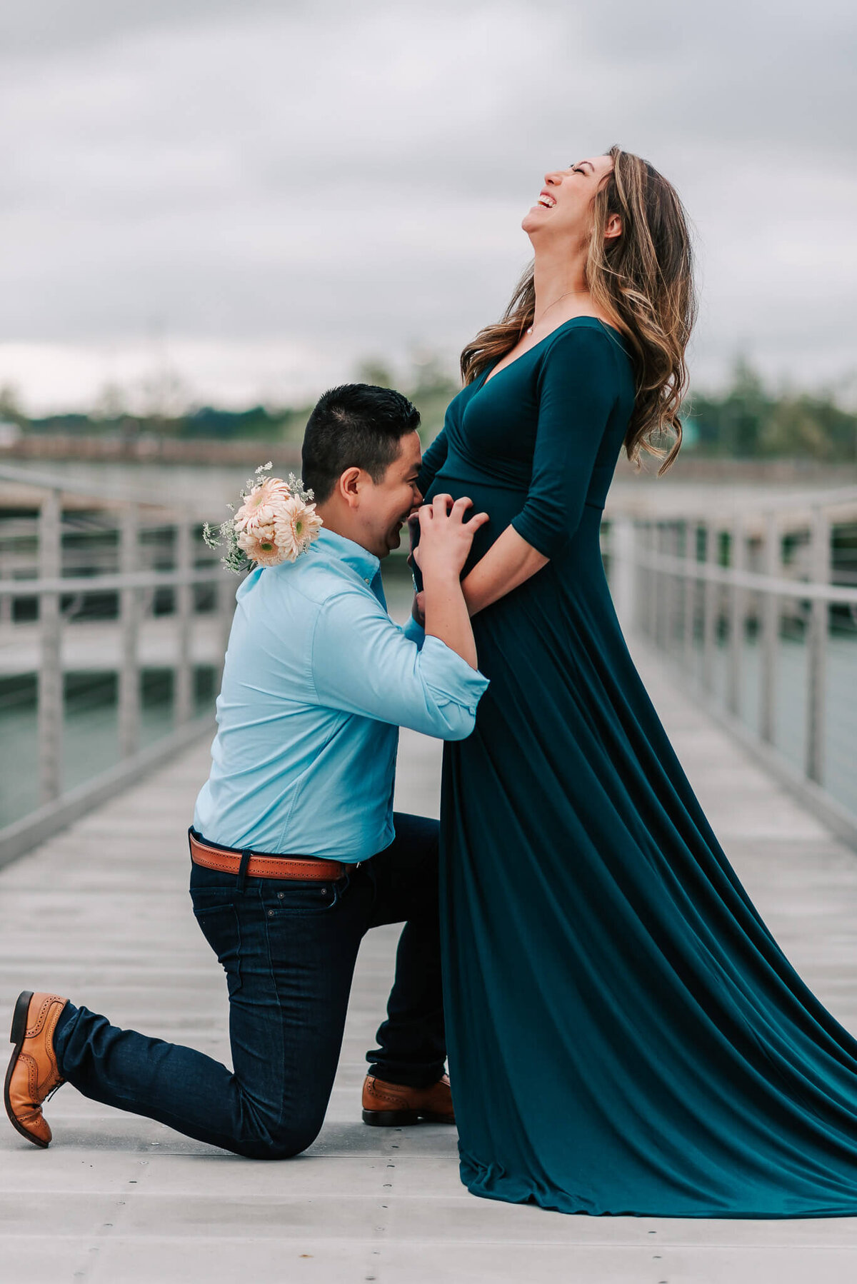 A joyful moment shared by a couple during their maternity session by Denise Van, a northern virginia maternity photographer