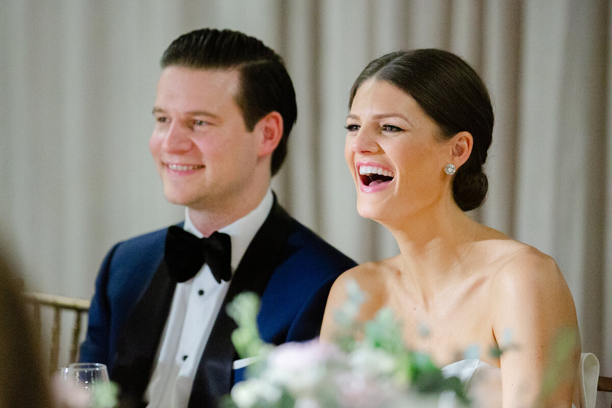 bride and groom laugh during their wedding reception in Chicago