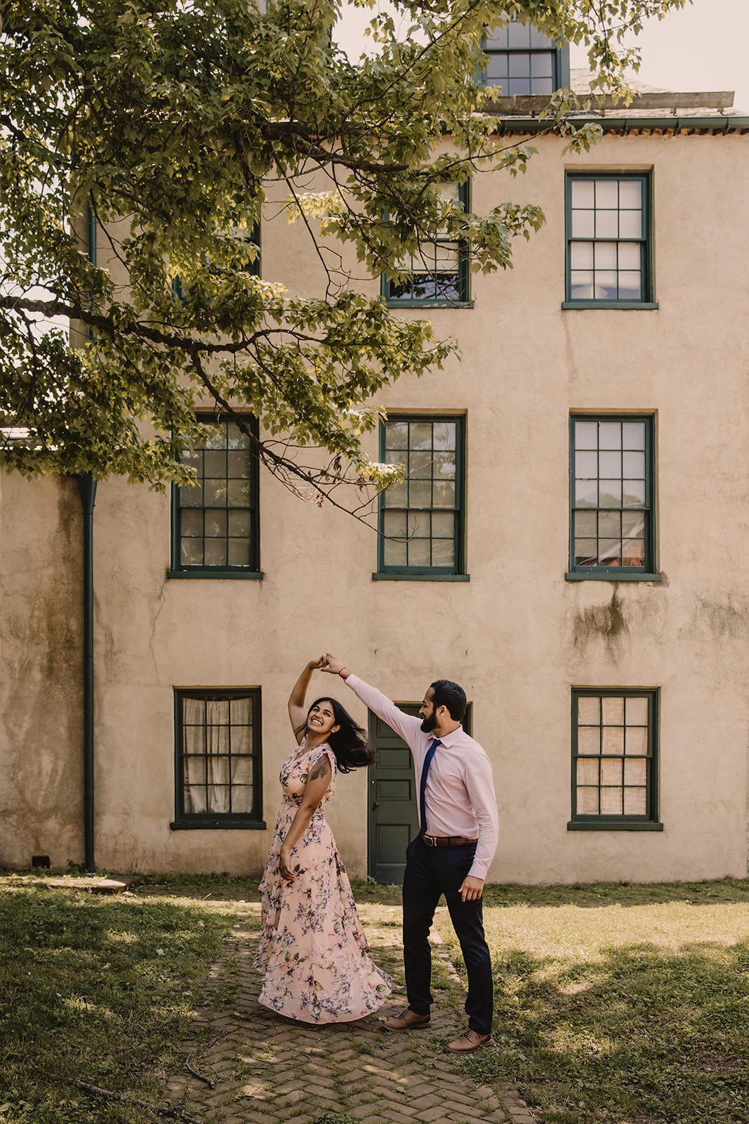 A couple dancing outside a building 