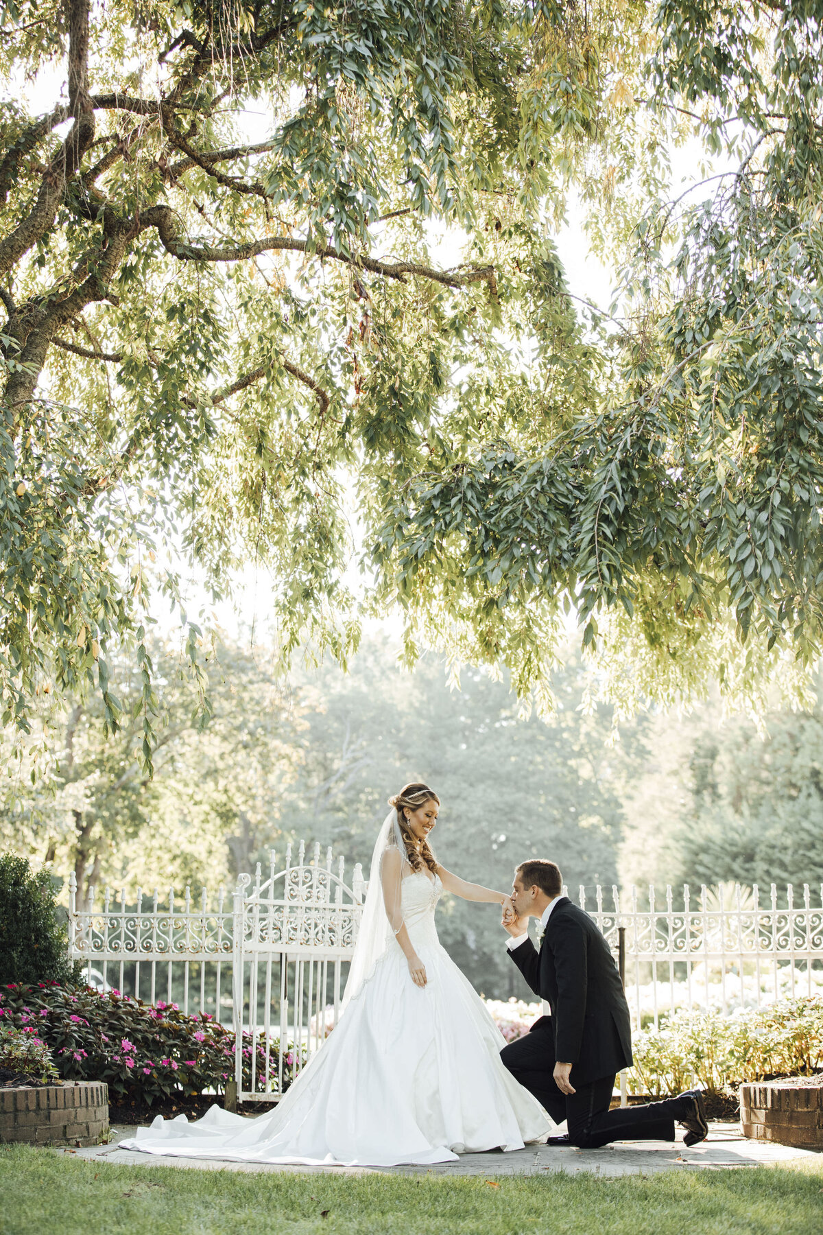 shadowbrook-at-shrewsbury-groom-kissing-brides-hand-on-one-knee-shrewsbury-new-jersey