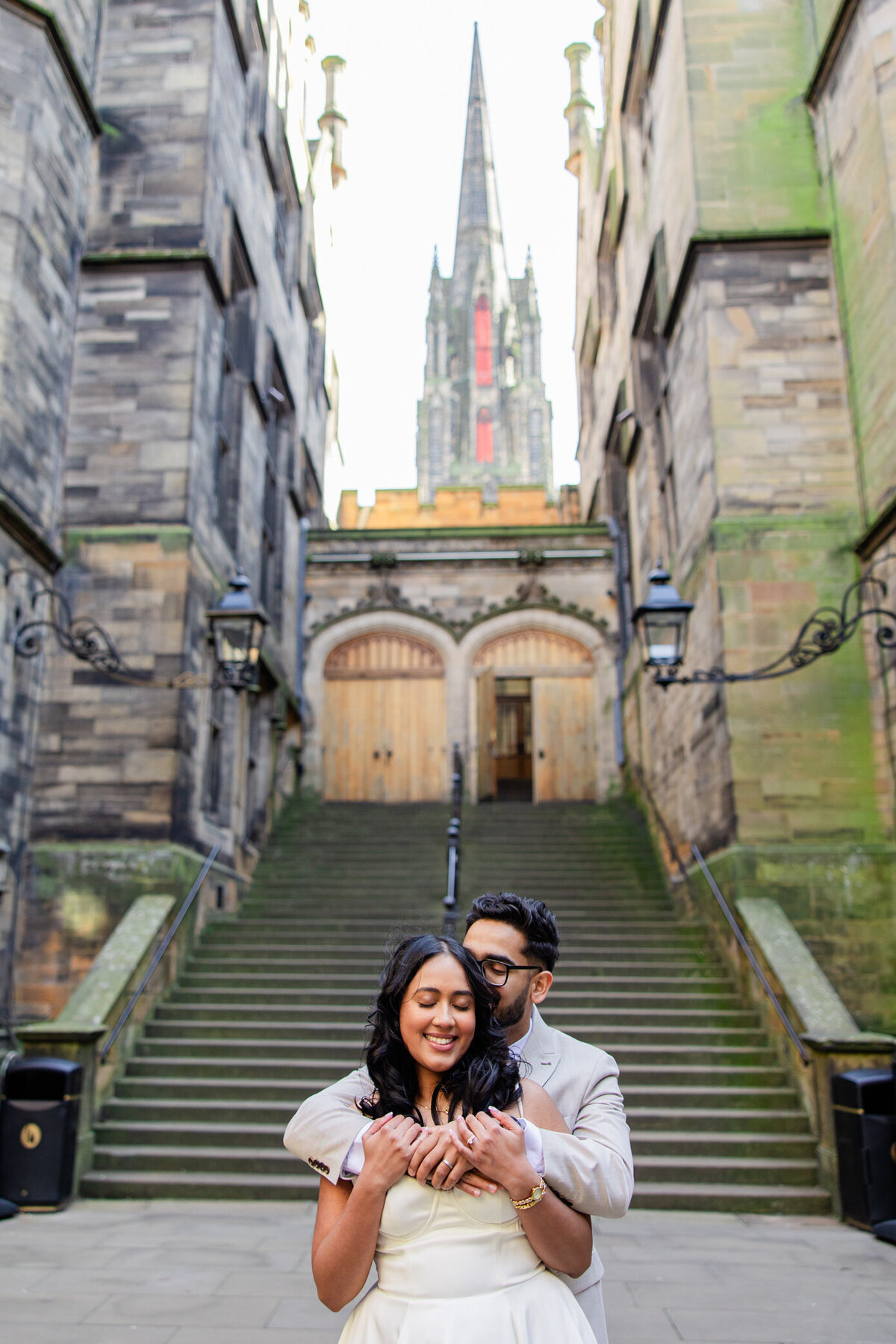 bride and groom hug in courtyard