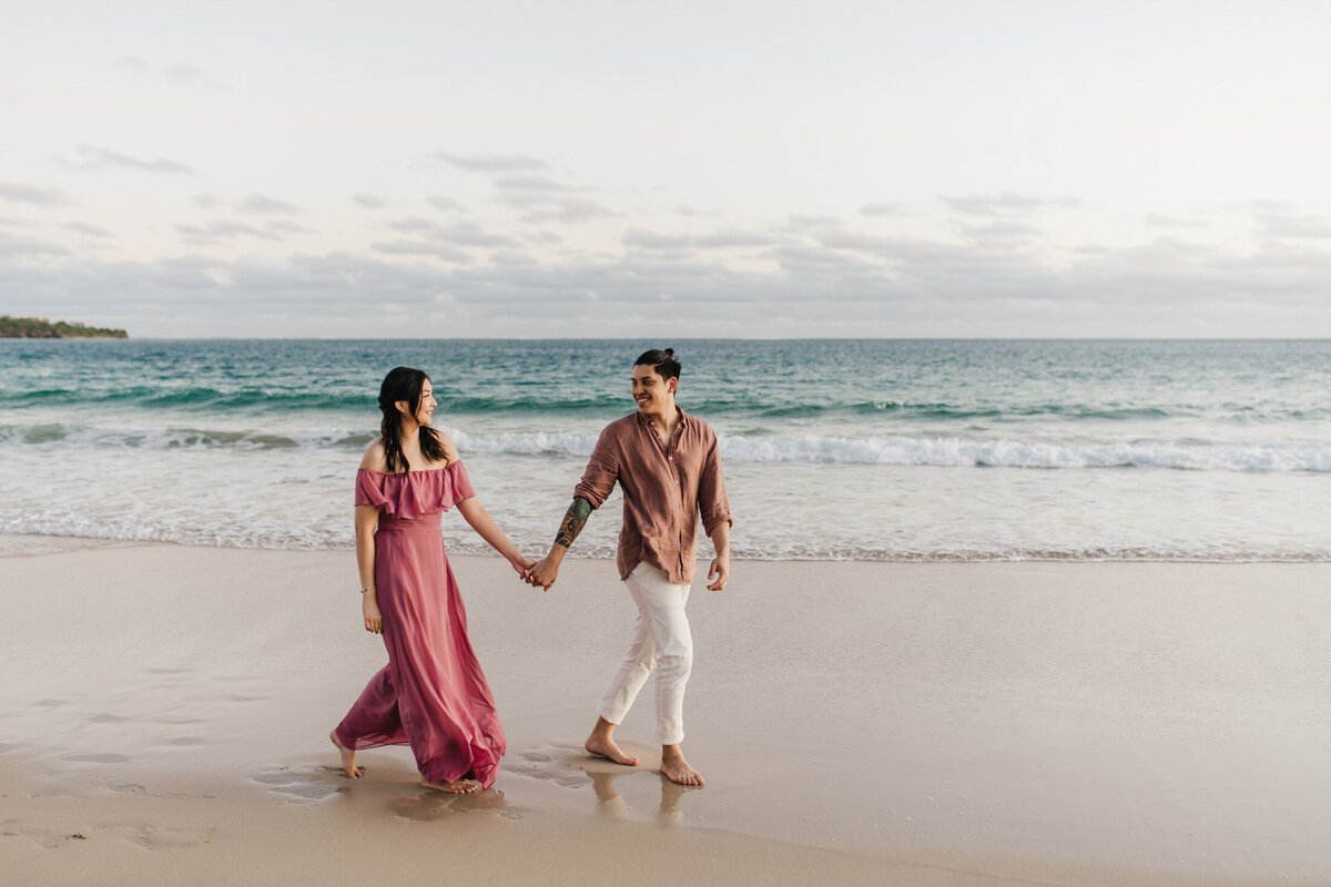 couple hand in hand on beach