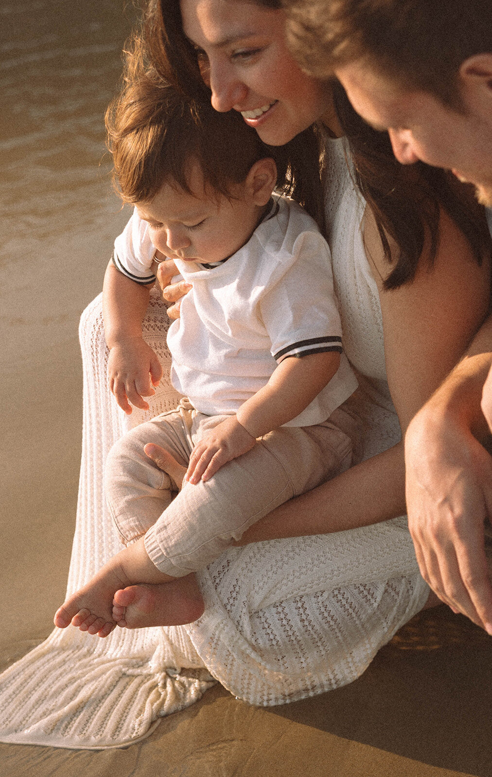 Mom holding her baby close during a family photo session at Shaw’s Cove in Laguna Beach.