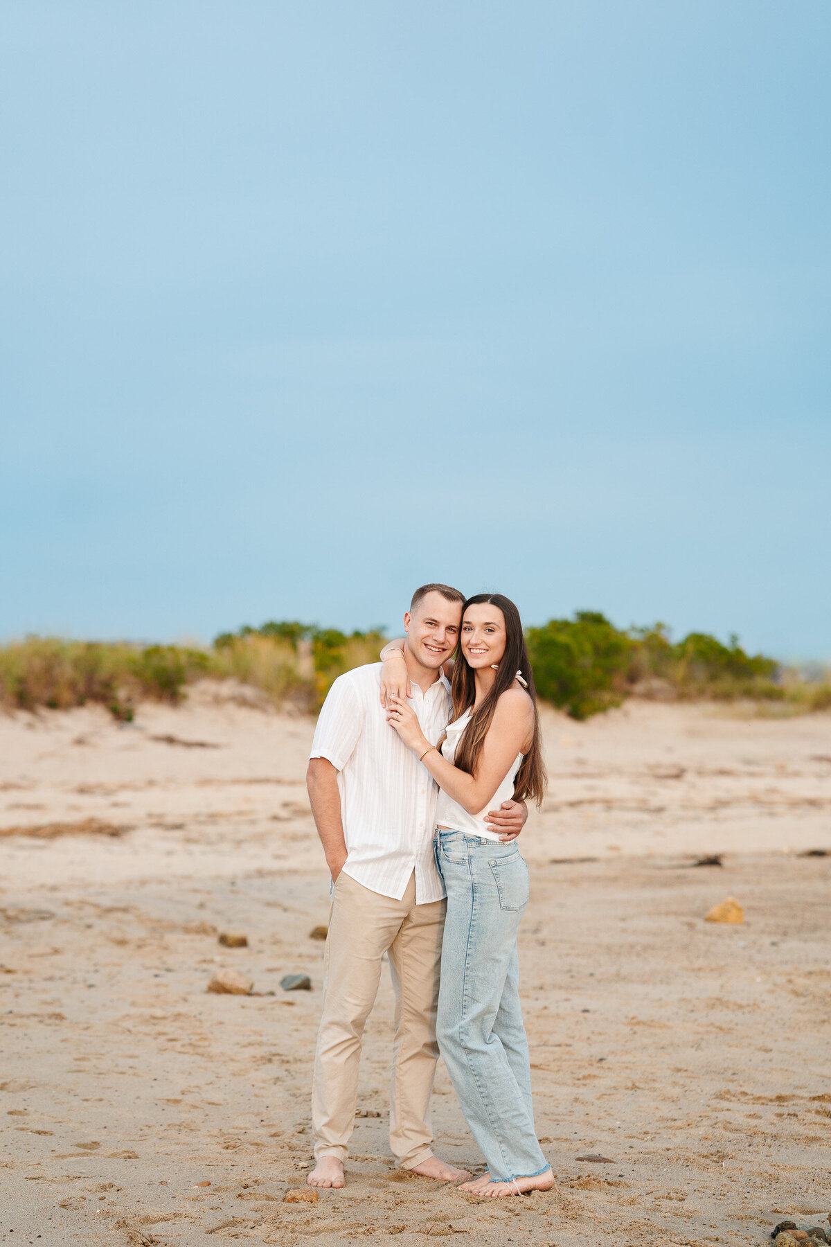 Candid ocean engagement portraits in New England with relaxed emotional storytelling
